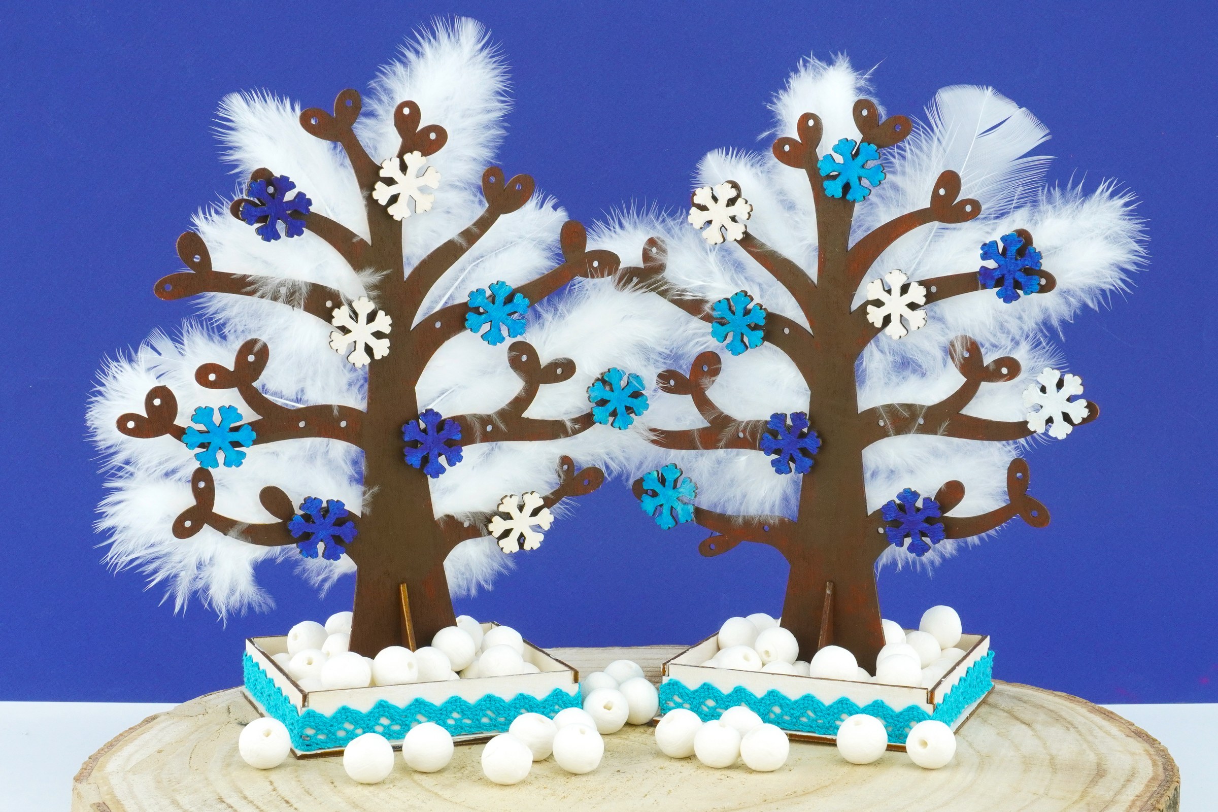 Enfant réalisant une activité sur le thème de l'hiver avec des flocons en papier et du coton sur une table